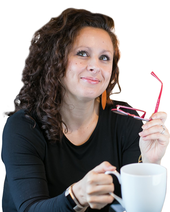 Catherine Pearce, owner of Eddington 10, holding her glasses and a coffee mug