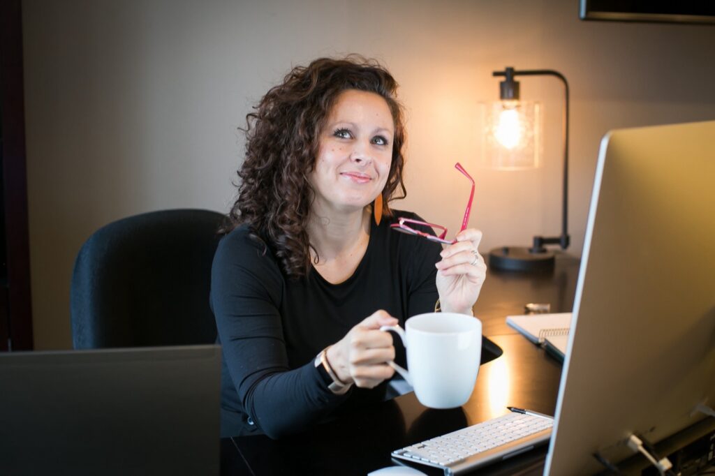 Catherine Pearce at her desk with a coffee mug